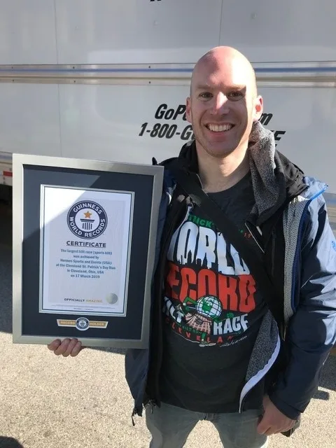 Cleveland St. Patrick's Day Run organizer holding Guinness World Record plaque